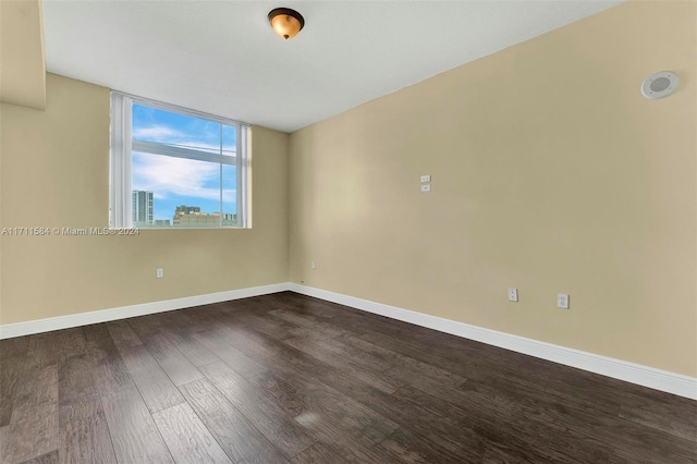 spare room with dark wood-type flooring