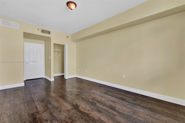 spare room featuring dark hardwood / wood-style flooring