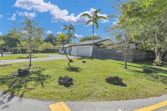 exterior space featuring a garage and a yard