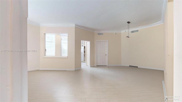 unfurnished room featuring ornamental molding