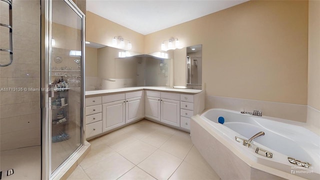 bathroom with tile patterned floors, vanity, and separate shower and tub