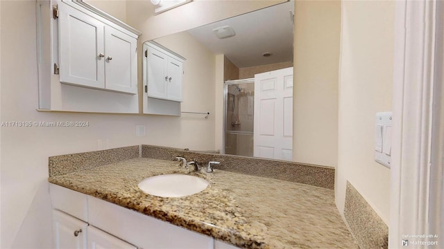 bathroom featuring vanity and an enclosed shower