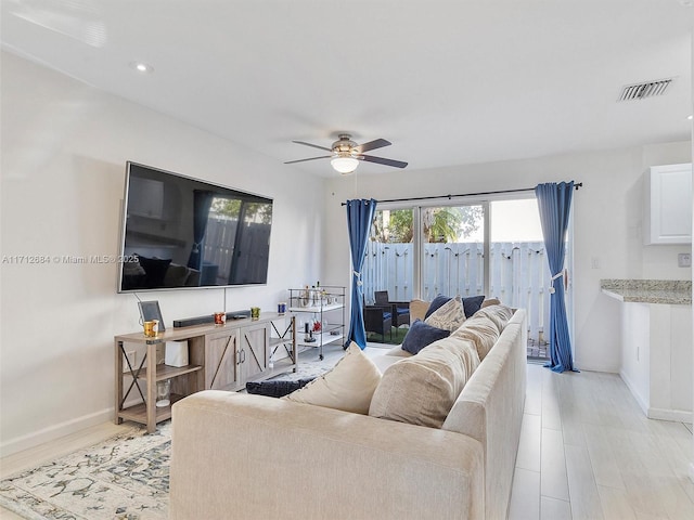living area with baseboards, recessed lighting, light wood-style floors, visible vents, and ceiling fan