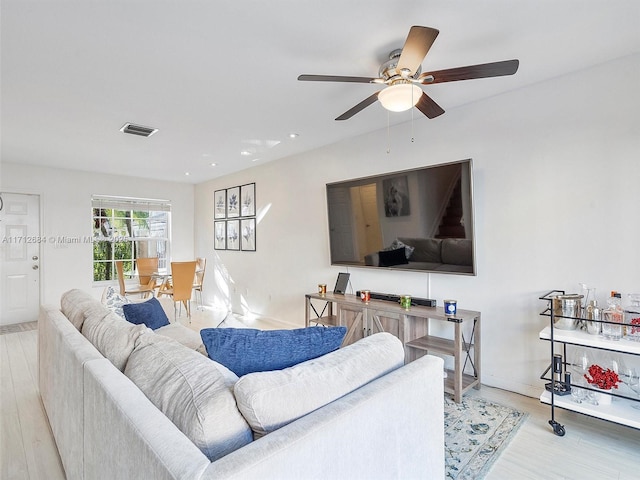 living area featuring ceiling fan, visible vents, recessed lighting, wood finished floors, and baseboards
