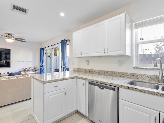 kitchen with kitchen peninsula, stainless steel dishwasher, ceiling fan, sink, and white cabinets