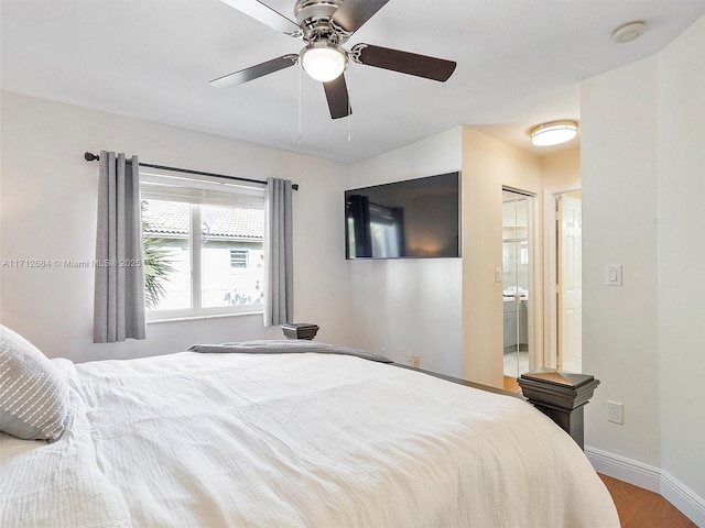 bedroom with wood finished floors, ceiling fan, baseboards, and ensuite bath