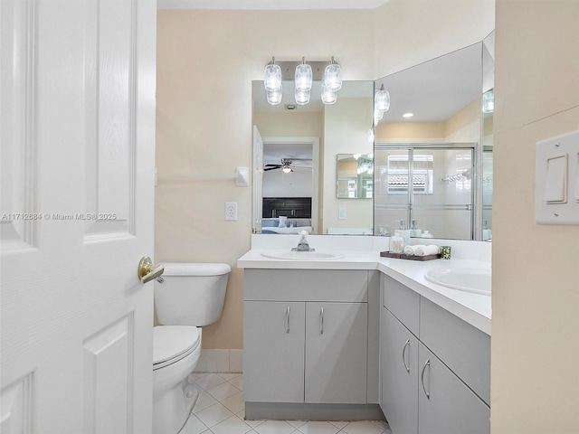bathroom featuring a shower stall, tile patterned flooring, toilet, a sink, and double vanity