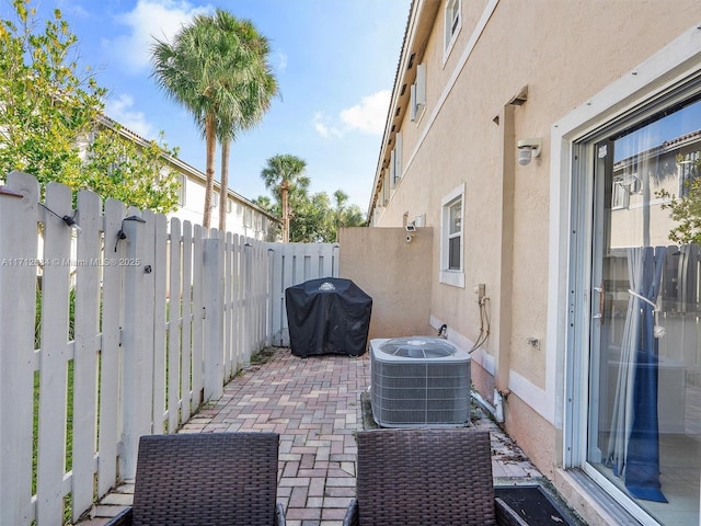 view of patio / terrace featuring central AC unit, a fenced backyard, and area for grilling