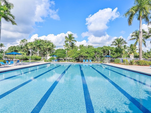 community pool featuring a patio and fence