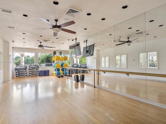 misc room featuring light wood-style floors, a ceiling fan, and visible vents