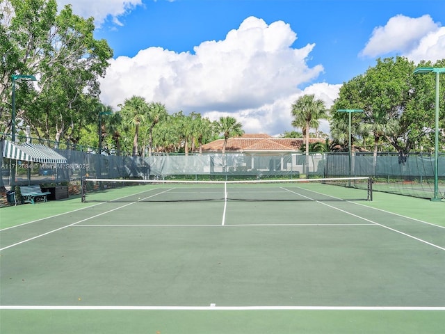 view of tennis court featuring fence