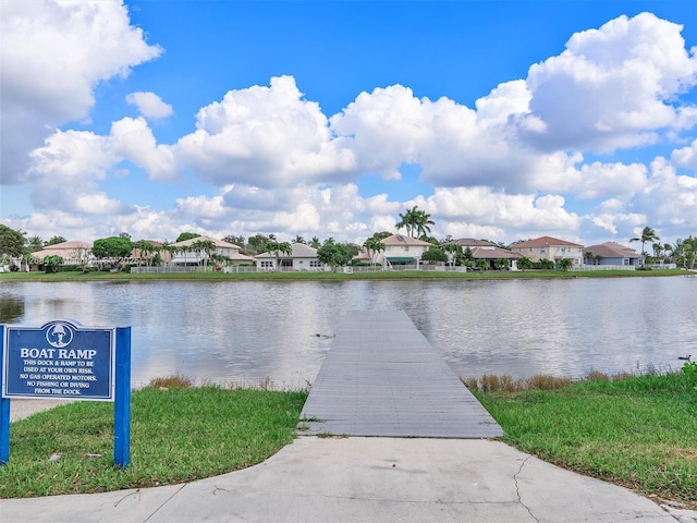 water view with a residential view and a dock