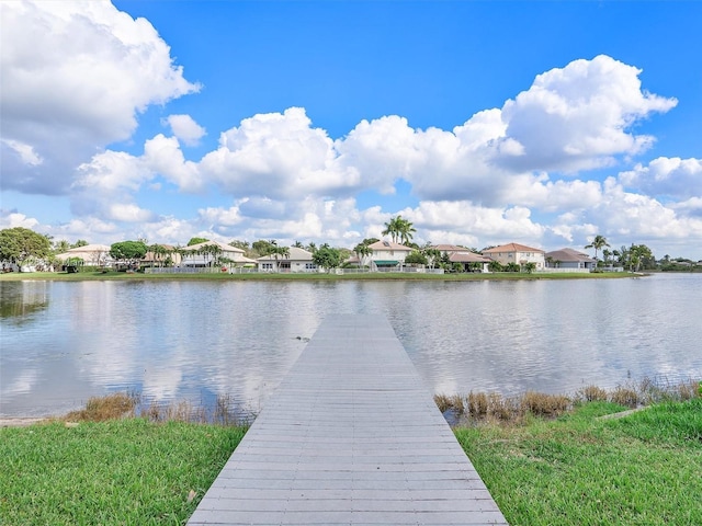 view of dock with a water view and a residential view