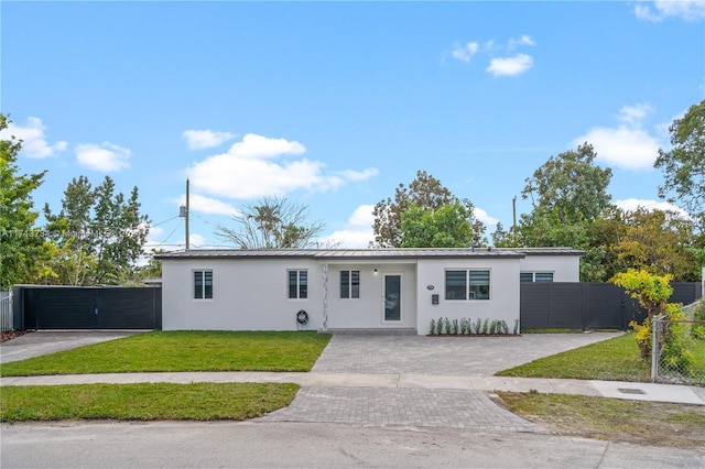 ranch-style home with a front lawn