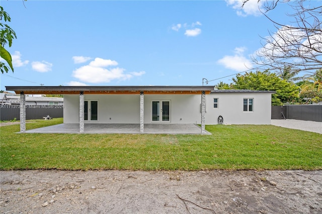 back of house with a yard and a patio area