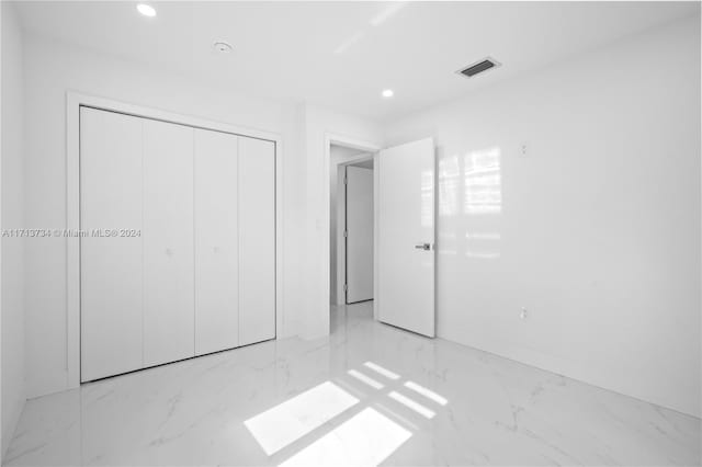 unfurnished bedroom with a closet