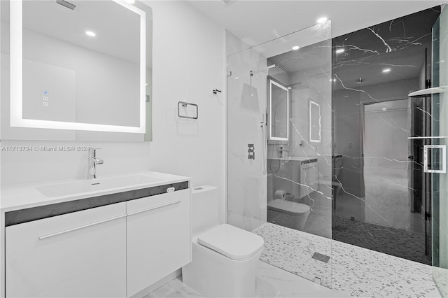 bathroom featuring vanity, toilet, and an enclosed shower