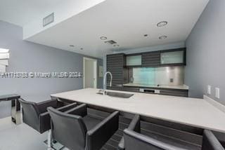 kitchen featuring a breakfast bar area and sink