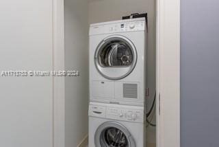 laundry room with stacked washer and clothes dryer