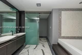 bathroom featuring vanity and a bathtub