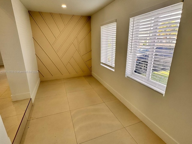 hallway featuring plenty of natural light and light tile patterned floors