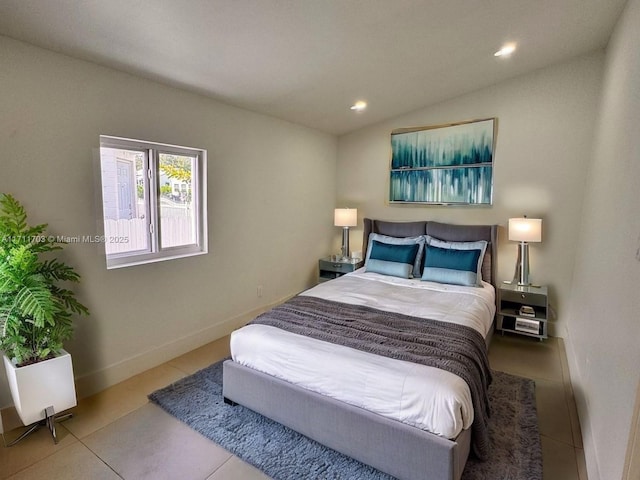 tiled bedroom featuring lofted ceiling, baseboards, and recessed lighting