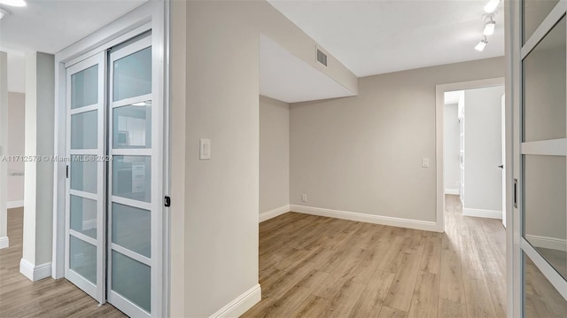 hallway with light hardwood / wood-style flooring