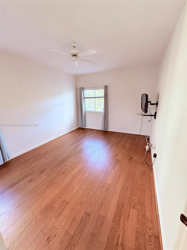 empty room featuring ceiling fan and light hardwood / wood-style floors