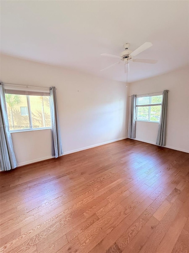 spare room featuring ceiling fan and light hardwood / wood-style floors