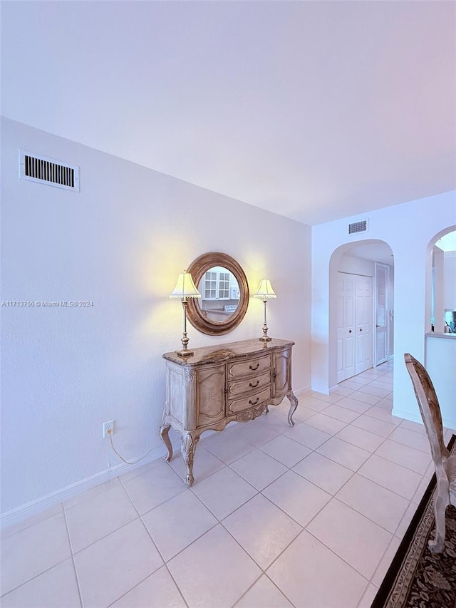 hall featuring light tile patterned floors