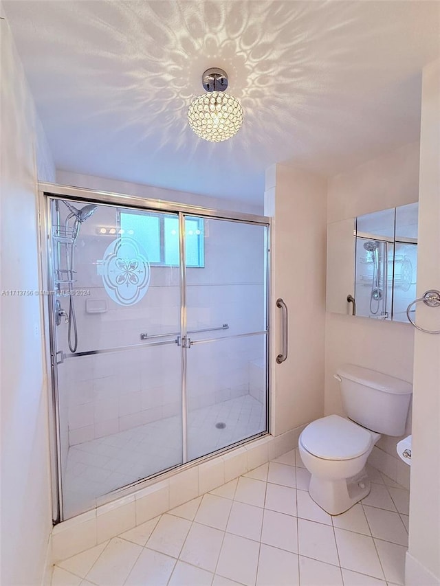 bathroom featuring tile patterned floors, toilet, and walk in shower