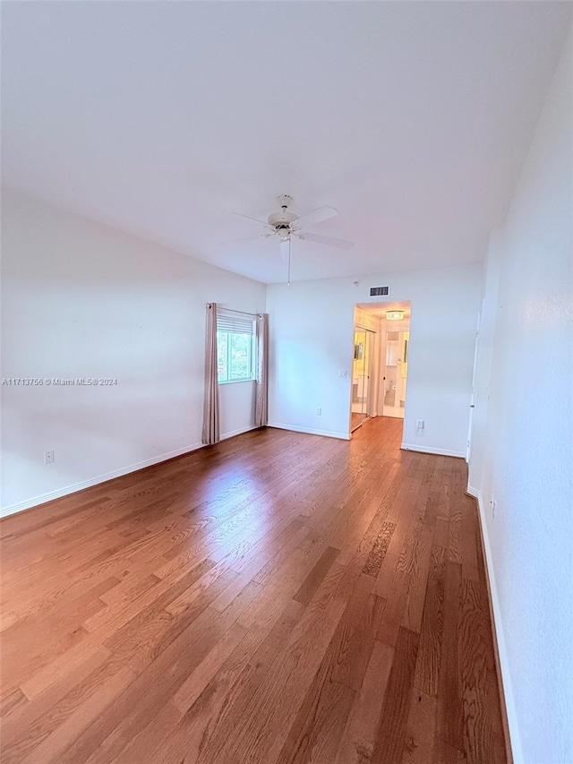 spare room featuring wood-type flooring and ceiling fan