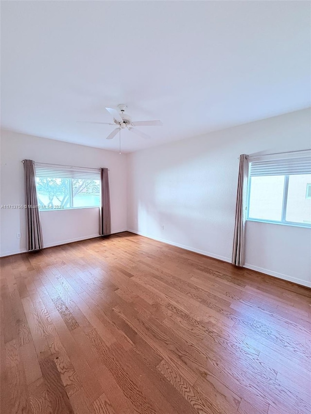 spare room with ceiling fan and hardwood / wood-style floors