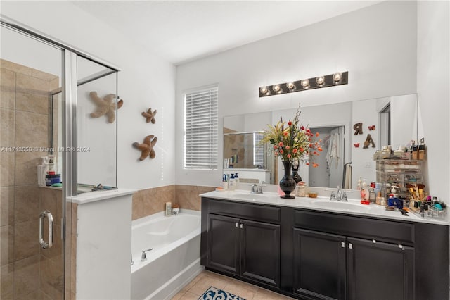 bathroom featuring tile patterned floors, vanity, and plus walk in shower