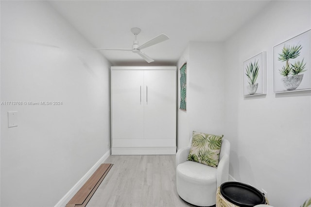 living area featuring ceiling fan and light wood-type flooring