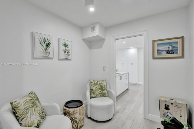 sitting room with light hardwood / wood-style floors