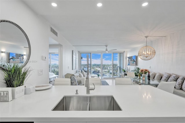 kitchen with pendant lighting, a notable chandelier, and sink