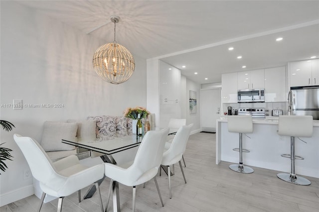 dining room featuring a chandelier and light wood-type flooring