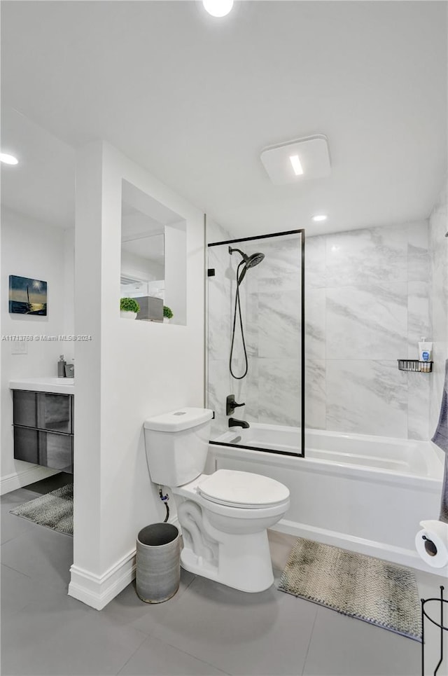 full bathroom with vanity, tiled shower / bath combo, and toilet