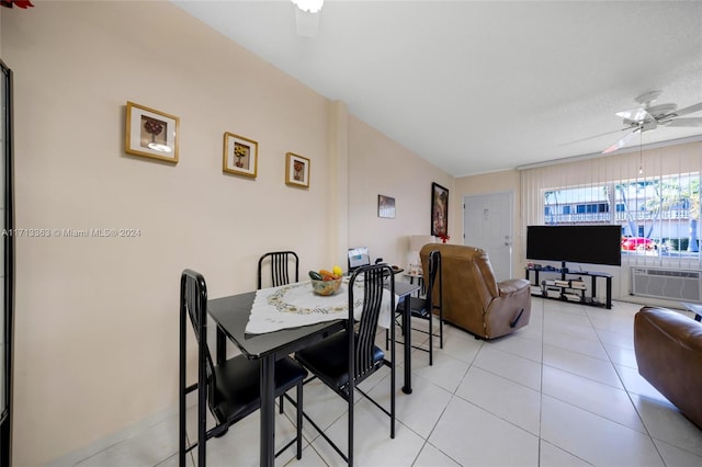 dining room with a textured ceiling, ceiling fan, light tile patterned floors, and a wall mounted air conditioner