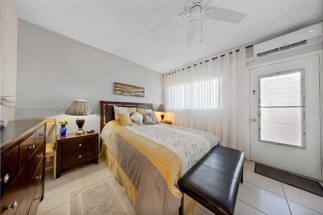 bedroom with an AC wall unit, ceiling fan, and light tile patterned flooring