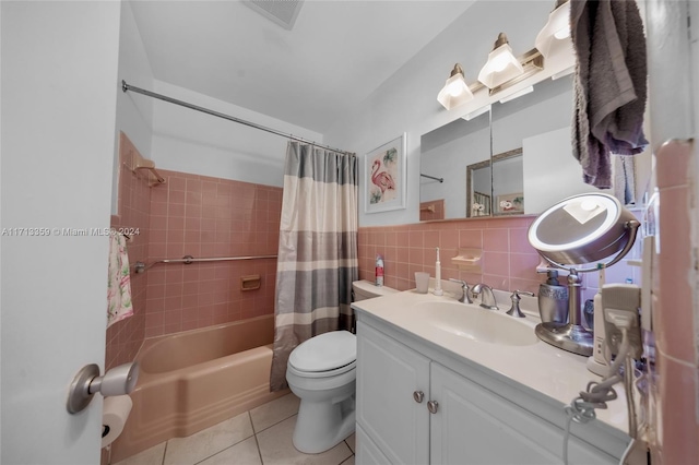 full bathroom with vanity, backsplash, tile patterned flooring, shower / bath combo with shower curtain, and tile walls