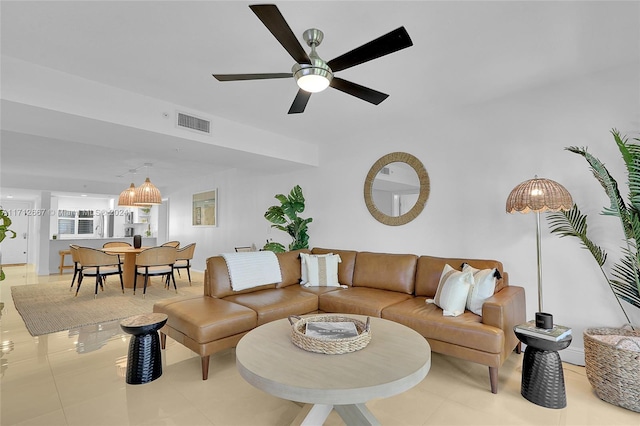 tiled living room featuring ceiling fan