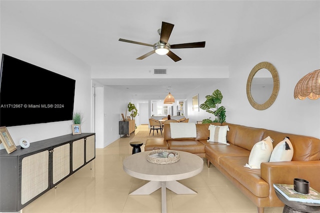 tiled living room with ceiling fan