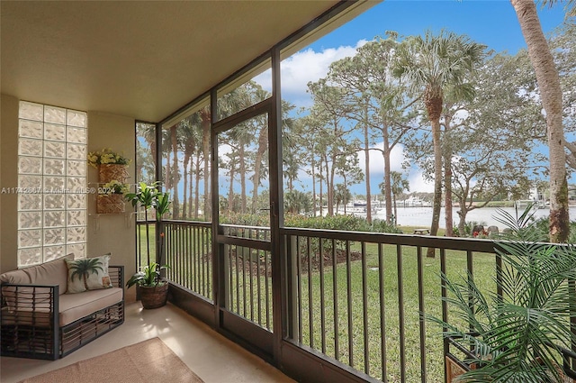 unfurnished sunroom featuring a water view