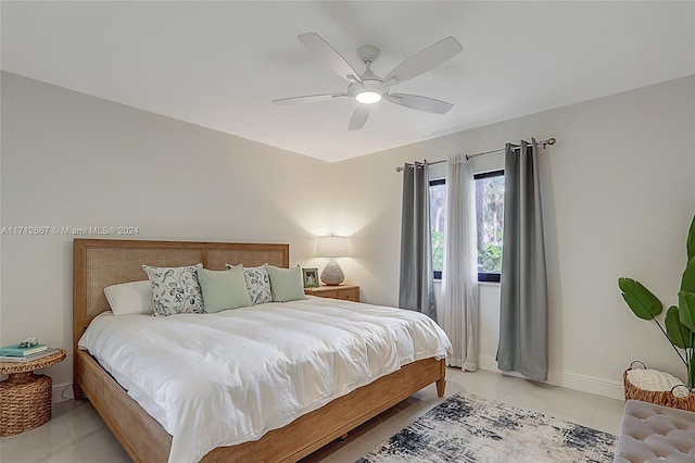 tiled bedroom featuring ceiling fan