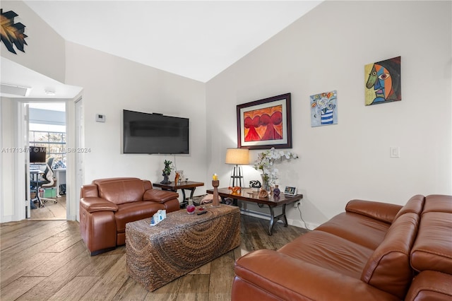 living room with hardwood / wood-style floors and lofted ceiling