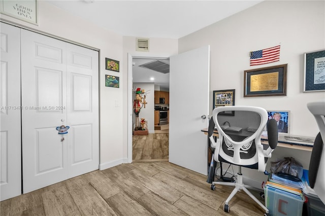 office area with light hardwood / wood-style floors