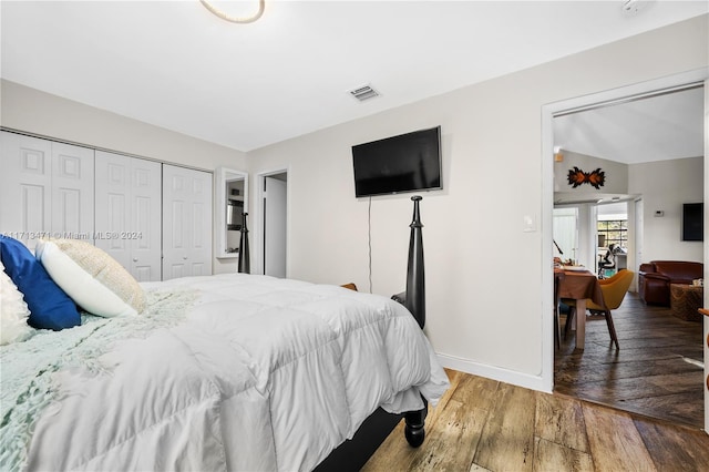 bedroom featuring wood-type flooring and a closet