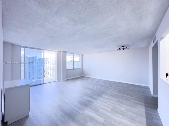 unfurnished room with a textured ceiling